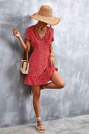 a woman leaning against a wall wearing a straw hat