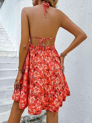 a woman wearing a red dress with a floral print