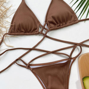 a woman's bikini top and a cucumber on a table