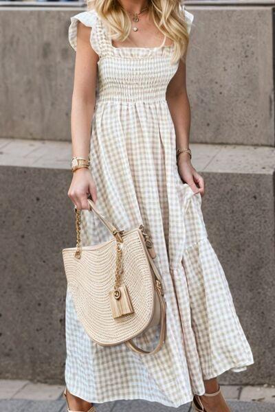 a woman in a white dress carrying a beige purse