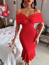 a woman in a red dress posing for a picture