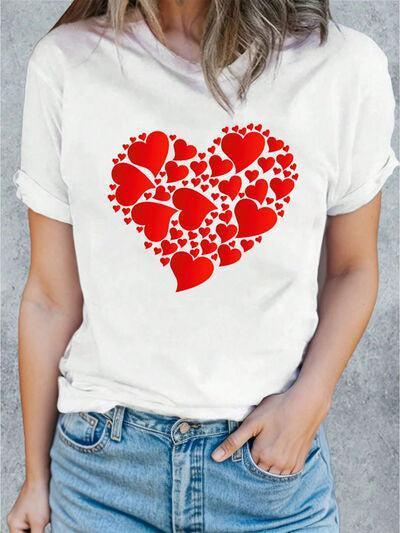 a woman wearing a white t - shirt with red hearts on it