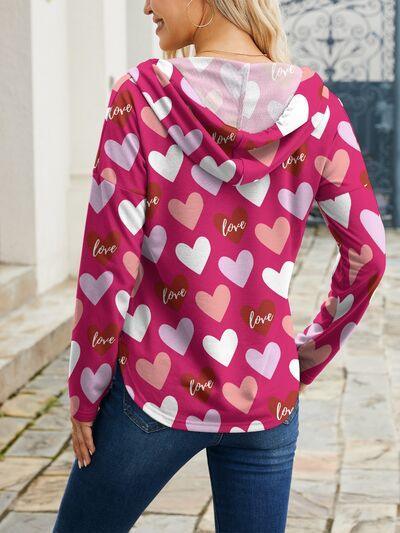 a woman wearing a hoodie with hearts on it