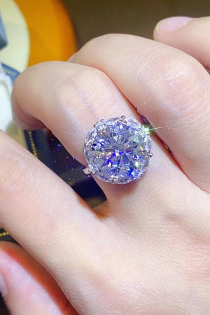 a close up of a person's hand with a ring on it