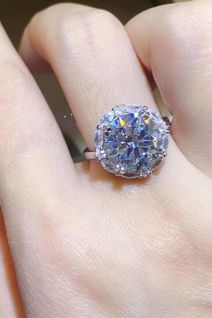 a close up of a person's hand with a ring on it