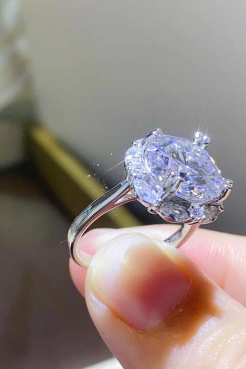 a close up of a person holding a ring