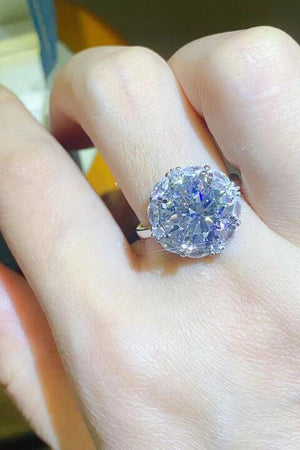 a close up of a person's hand with a ring on it