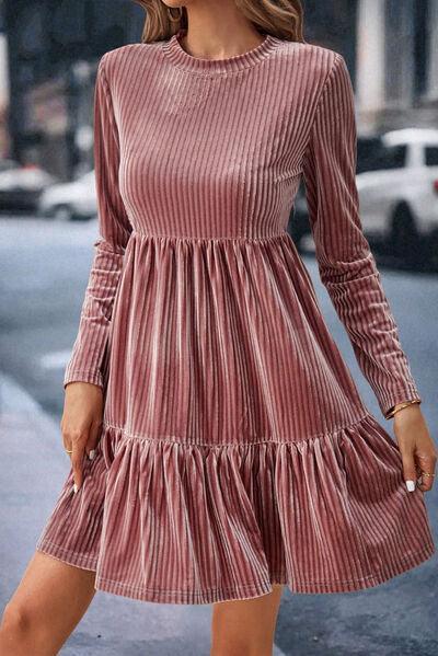 a woman in a pink dress is walking down the street