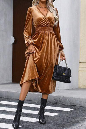 a woman wearing a brown dress and black boots