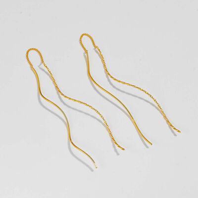 a pair of gold - plated metal hair clips