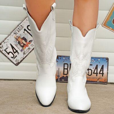 a close up of a person wearing white cowboy boots