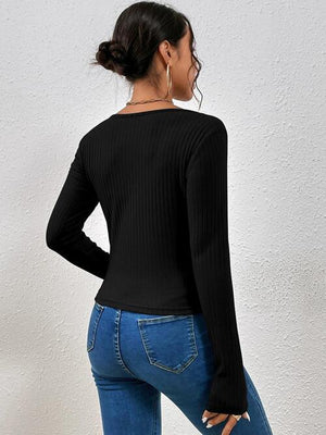 a woman wearing a black top and jeans