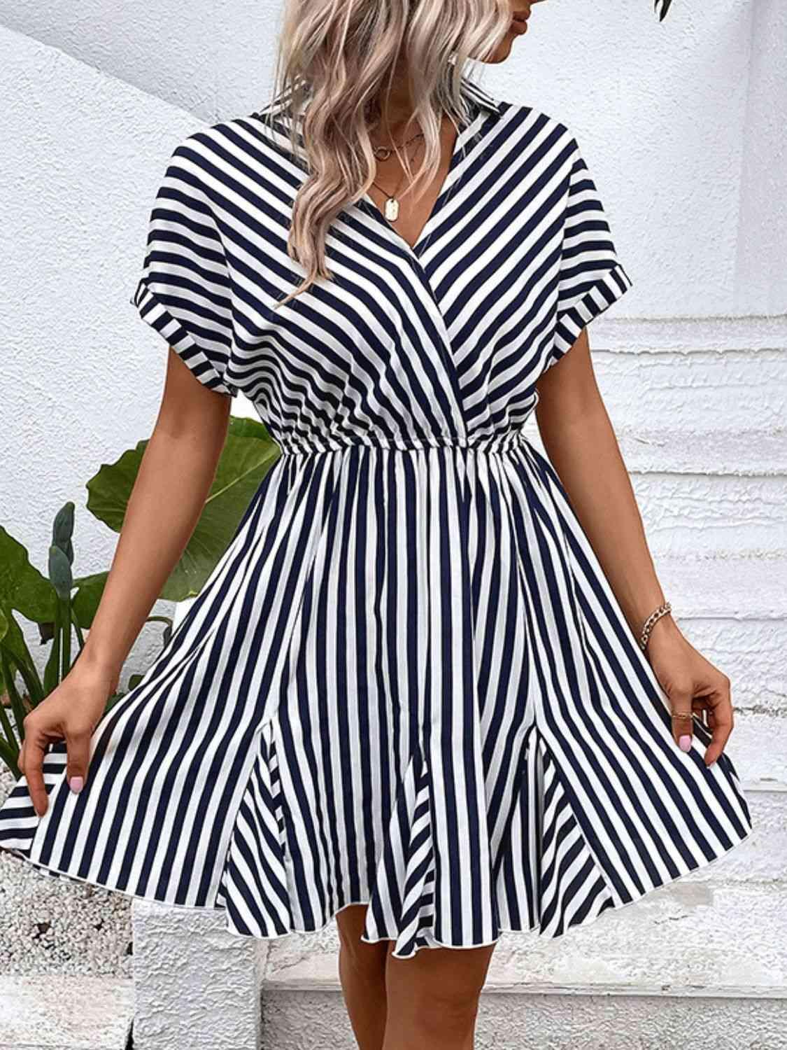 a woman wearing a black and white striped dress