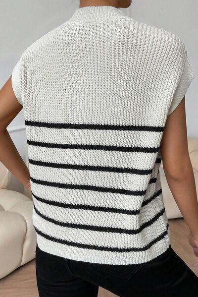 a woman wearing a white and black striped sweater