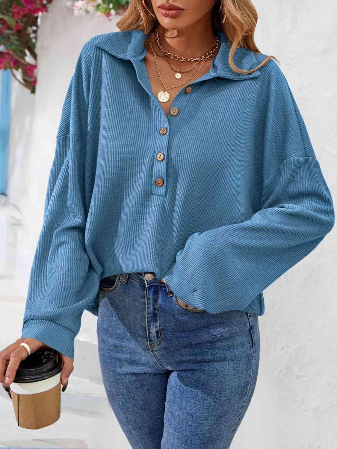 a woman wearing a blue shirt and jeans