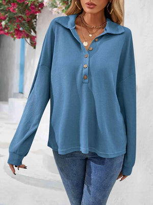 a woman wearing a blue sweater and jeans