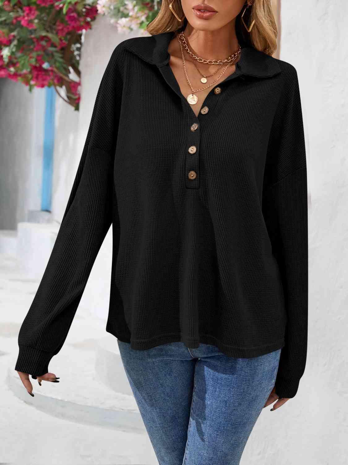 a woman wearing a black sweater and jeans