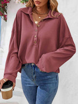 a woman wearing a pink shirt and jeans