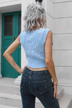 a woman with grey hair wearing a blue sweater and jeans