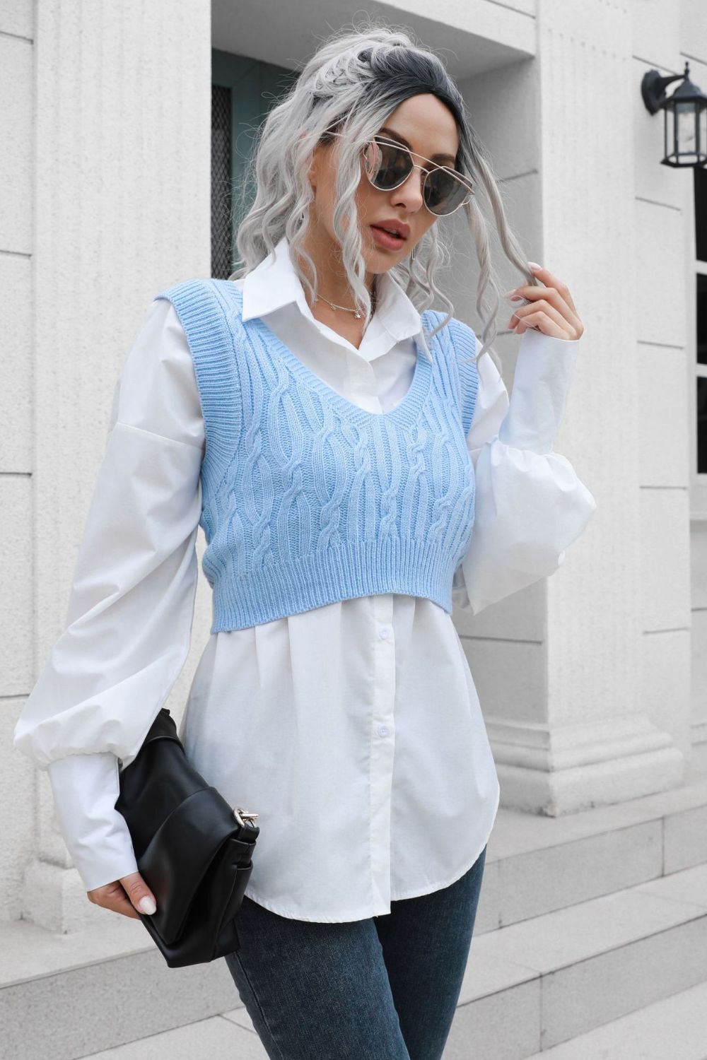 a woman with grey hair wearing a blue and white top