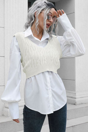 a woman with grey hair wearing a white shirt and jeans