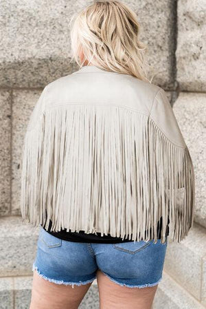 a woman wearing a tan leather jacket and denim shorts