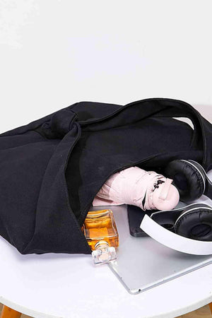 a black bag sitting on top of a white table