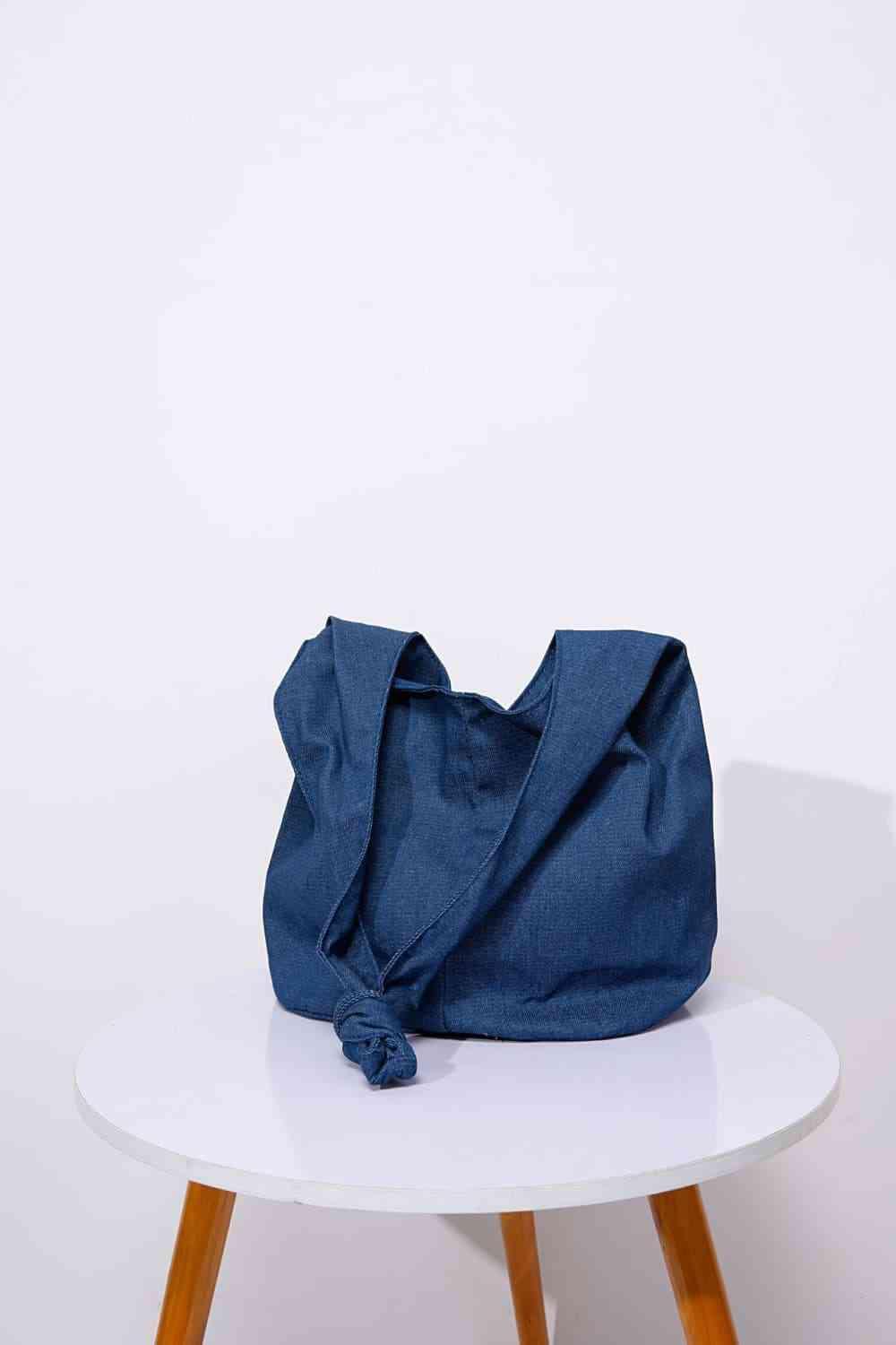 a blue bag sitting on top of a white table