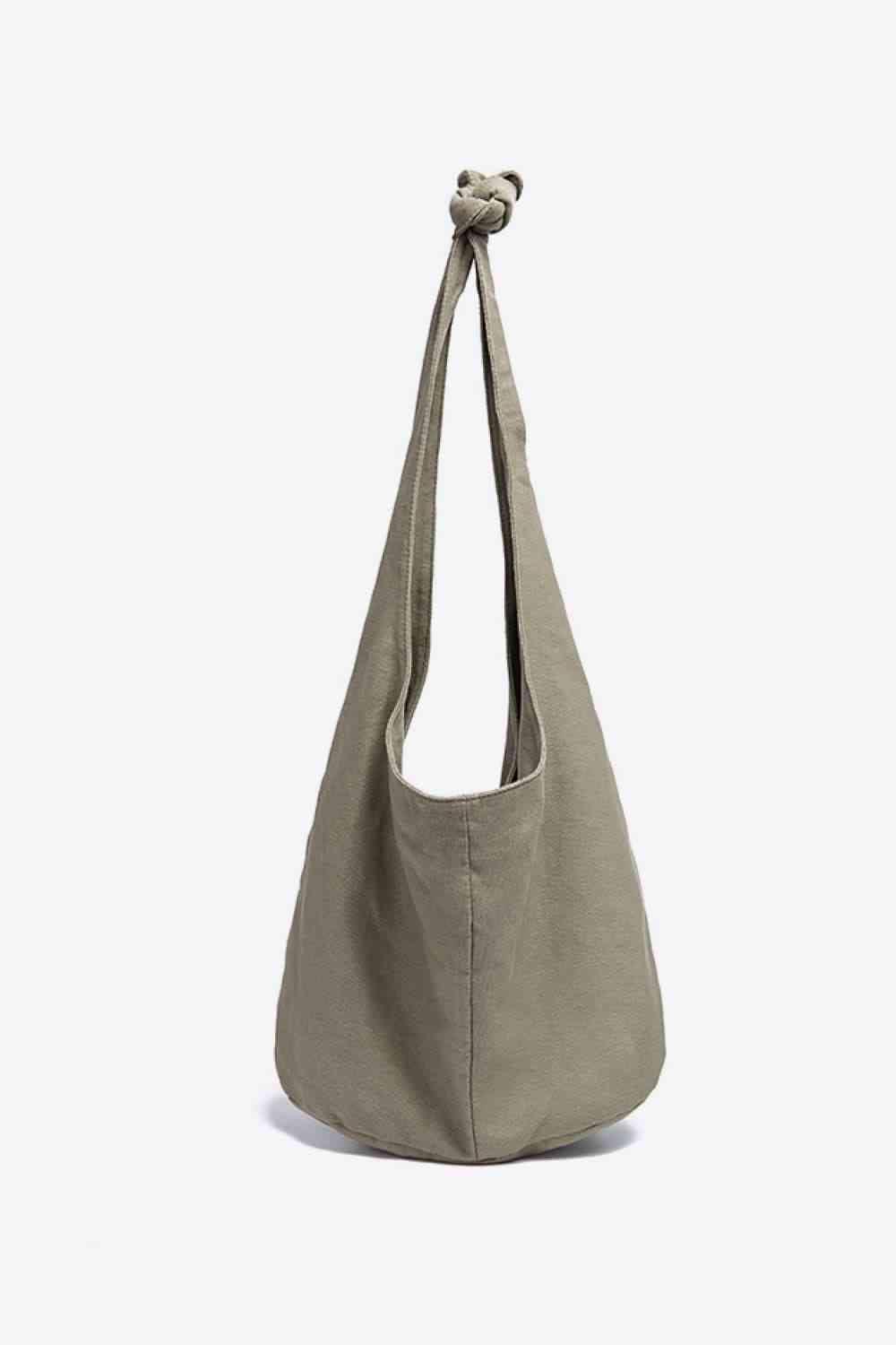 a gray bag with a knot on the handle