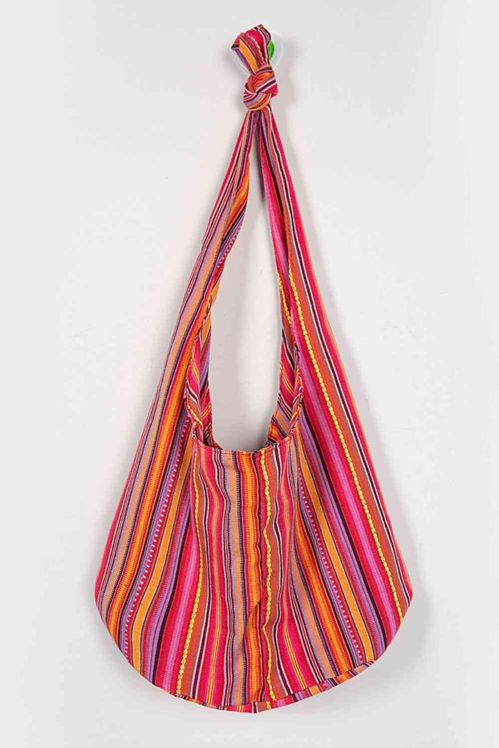 a colorful striped bag hanging on a wall