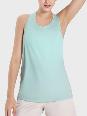 a woman wearing a light blue tank top