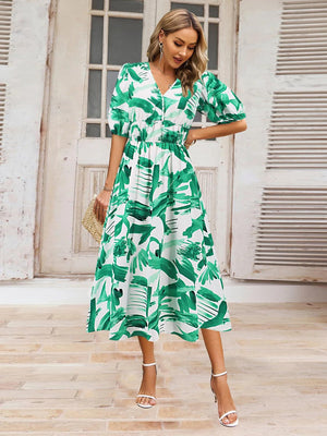 a woman wearing a green and white dress