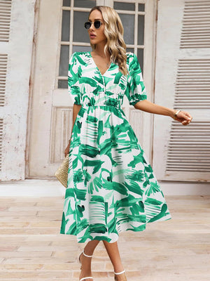 a woman wearing a green and white dress