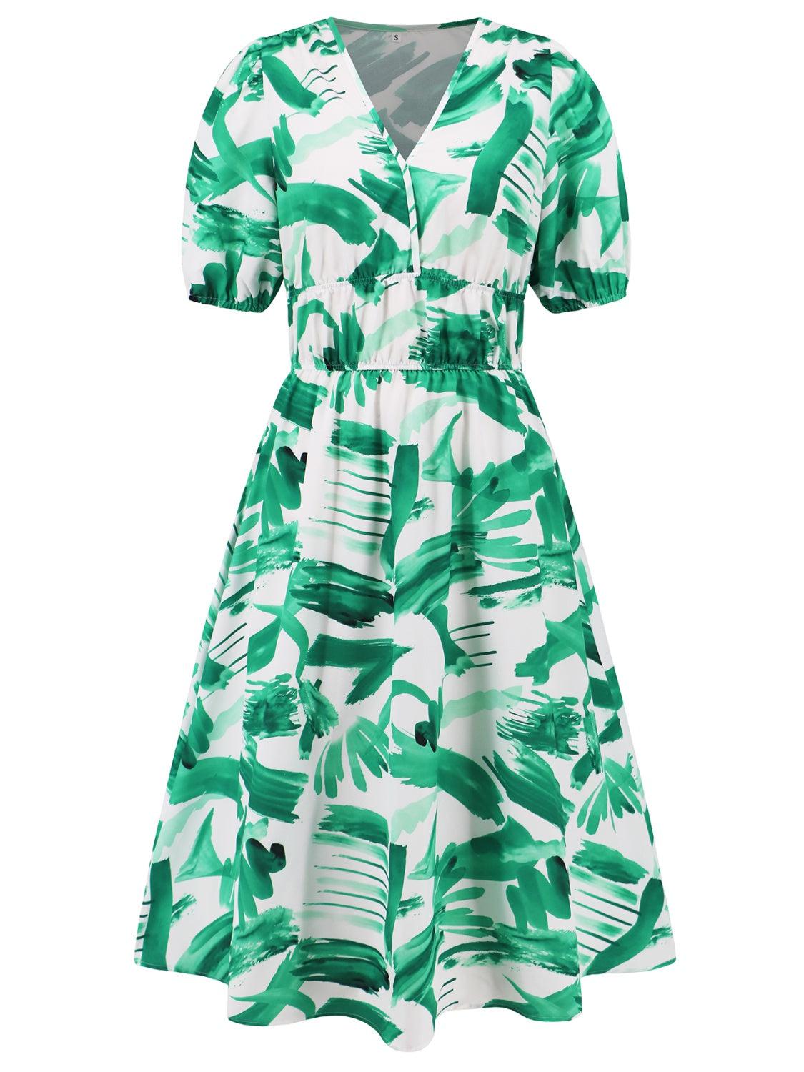 a white and green dress with green leaves on it