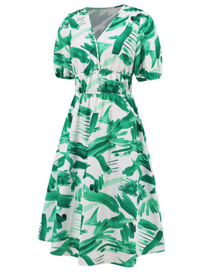 a green and white dress with green leaves on it