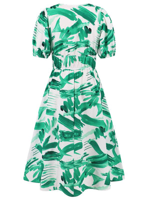 a green and white dress with palm leaves on it