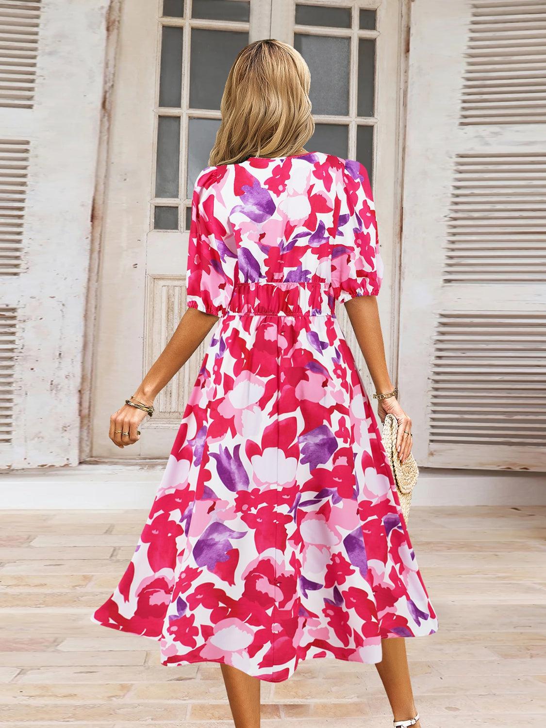 a woman in a red and pink floral print dress