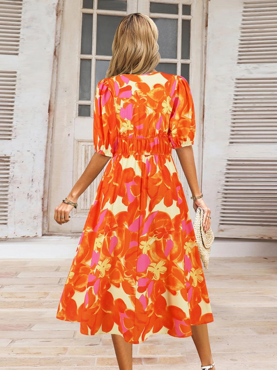 a woman in an orange floral print dress