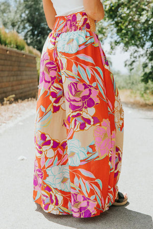 a woman standing on a road wearing a long skirt