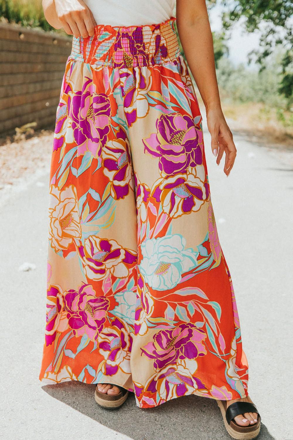 a woman wearing a white top and a colorful skirt