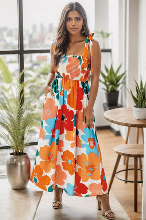 a woman standing in front of a window wearing a colorful dress