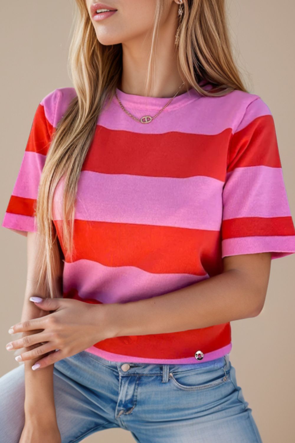 a woman wearing a pink and red striped shirt