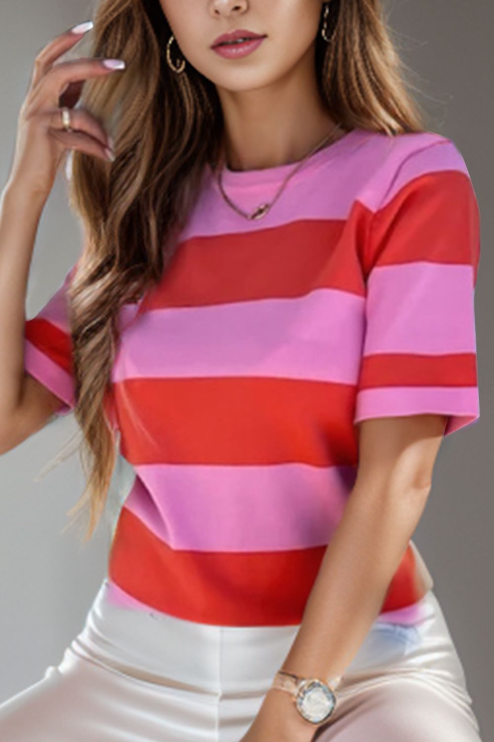 a woman in a pink and red striped shirt smoking a cigarette