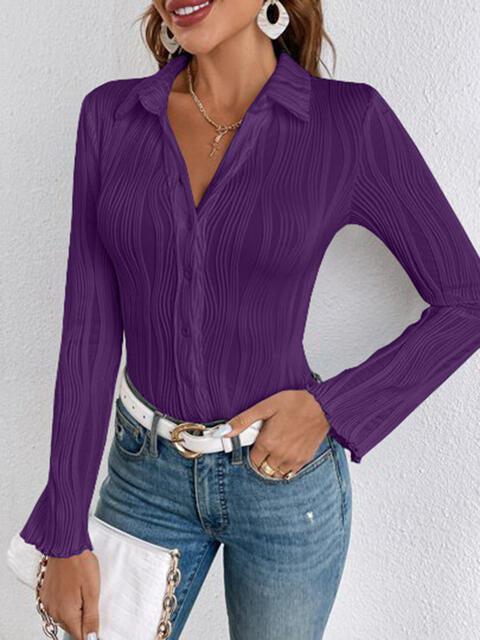 a woman wearing a purple shirt and jeans