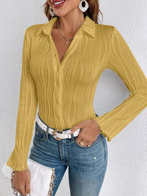 a woman wearing a yellow shirt and jeans