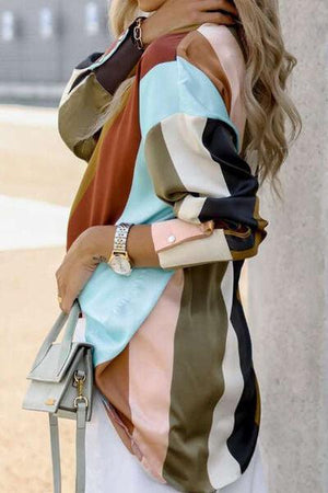 a woman standing next to a wall holding a purse