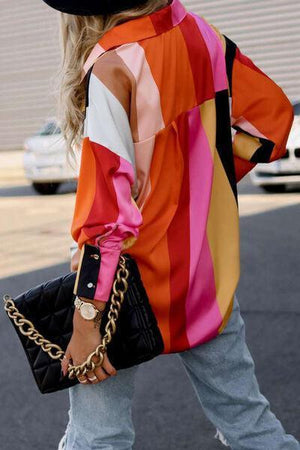 a woman walking down a street carrying a black purse