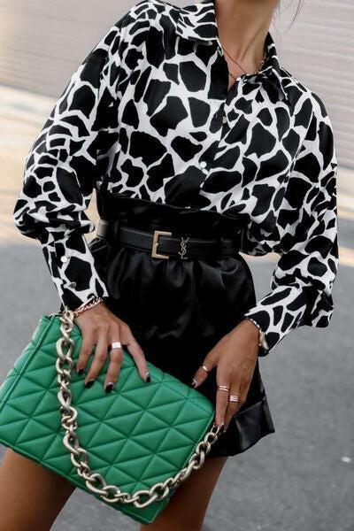 a woman in a black and white dress holding a green purse