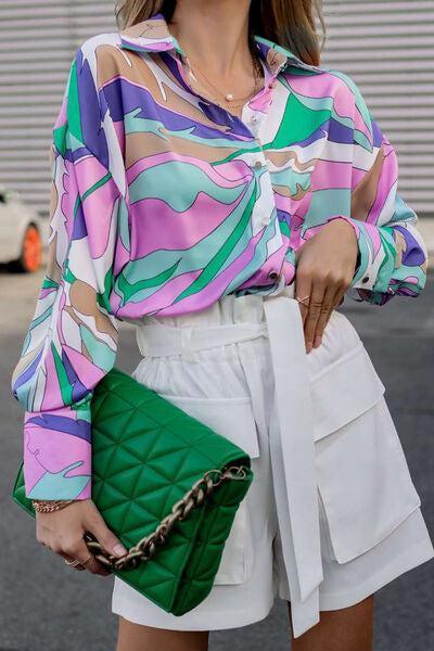 a woman wearing a colorful shirt and white shorts