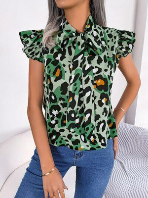 a woman wearing a green leopard print shirt